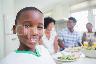 Happy family sitting down to dinner together