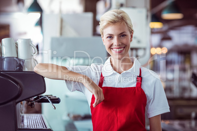 Pretty barista smiling at the camera