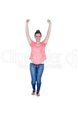 Happy pretty casual brunette cheering in front of camera