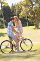 Young couple on a bike ride in the park