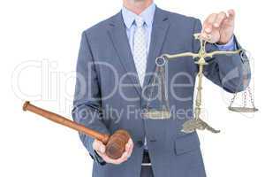 businessman holding scales of justice