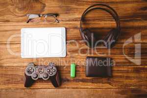 Tablet and music headphone next the joystick USB key and glasses