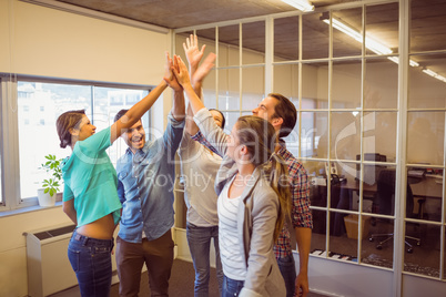 Creative business team raising their hands