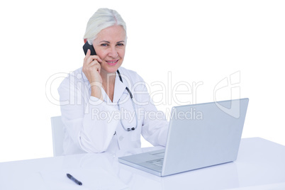 Doctor working on her laptop and calling