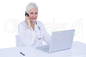 Doctor working on her laptop and calling