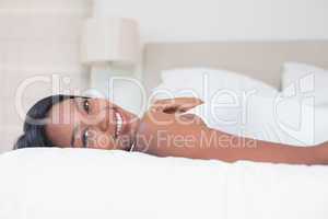 Relaxed woman lying on bed