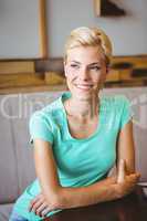 Pretty blonde woman looking away with arms crossed