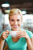 Pretty blonde holding cup of coffee