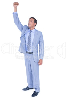 Businessman cheering with clenched fist