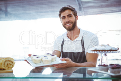 Smiling worker posing behind the counter