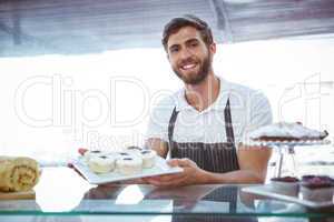 Smiling worker posing behind the counter