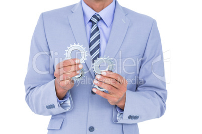 businessman holding a gear