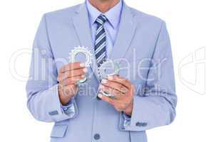 businessman holding a gear