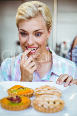 Pretty woman looking at a fruit pie