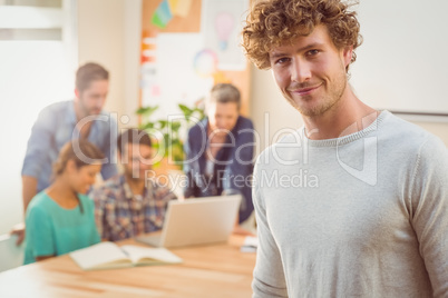 Portrait of a man with his colleague behind him