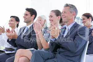 Business team applauding during conference