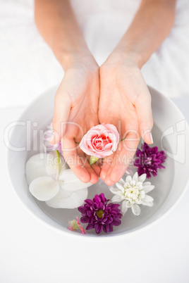 Petals of flower in wooden bowl