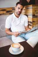 Young man reading a newspaper