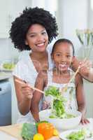 Mother and daughter making a salad together