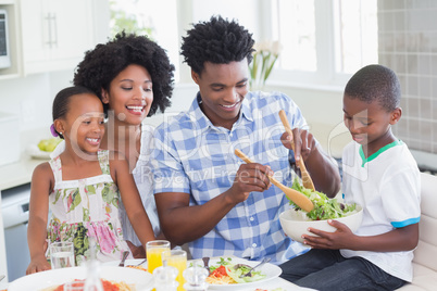 Happy family sitting down to dinner together