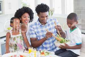 Happy family sitting down to dinner together