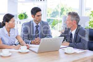 Businessman meeting with colleagues using laptop