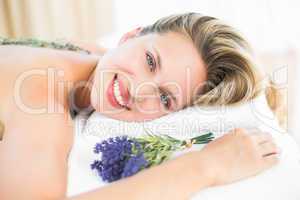 Beautiful blonde lying on massage table with lavanda