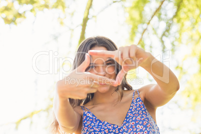 Pretty brunette doing frame with her fingers