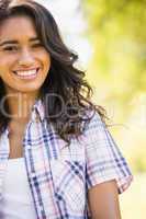 Pretty brunette looking at camera in the park