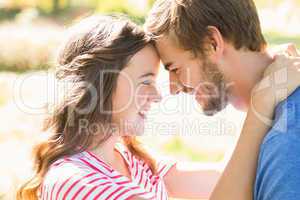 Cute coupe smiling at each other in park