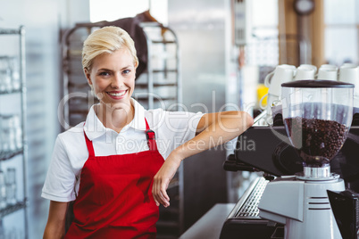 Pretty barista smiling at the camera