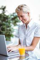 Happy pretty woman using her laptop computer