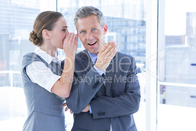 Secretive business colleagues whispering