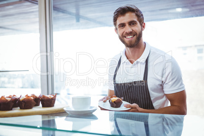 Smiling worker prepares breakfast