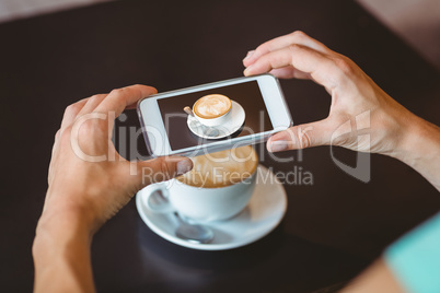 Woman taking picture with her smartphone