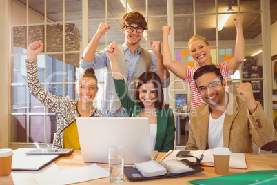 Group of young colleagues using laptop