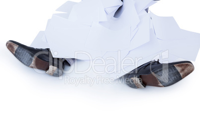 businessman burried under piece of paper