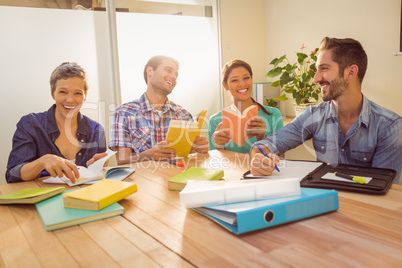 Group of colleagues reading books