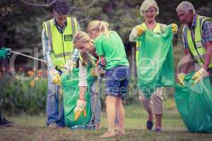 Happy family collecting rubbish