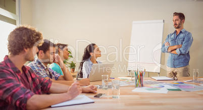 Casual businessman giving presentation to his colleagues