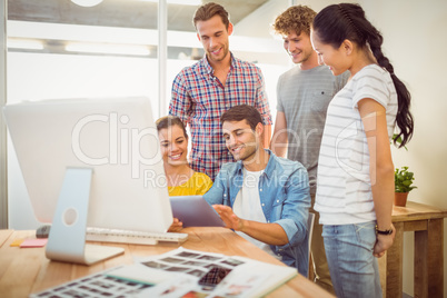 Creative business team gathered around a tablet
