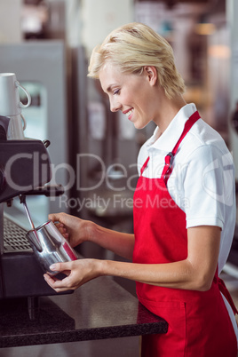 Pretty barista using the coffee machine