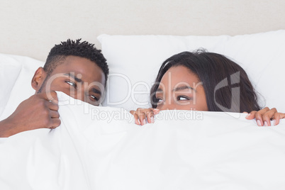 Happy couple in bed together