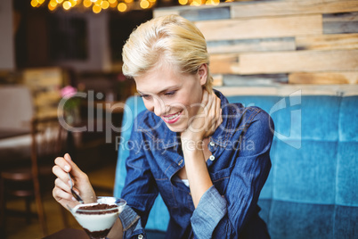 Smiling blonde eating a creamy chocolate