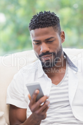 Handsome man using his smartphone