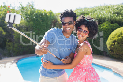 Happy couple using a selfie stick