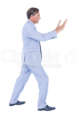 Businessman walking while gesturing with hands