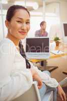 Smiling young businesswoman looking at the camera