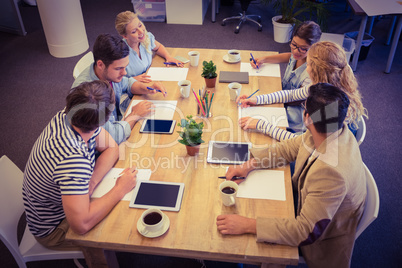 Creative colleagues with laptop and digital tablet