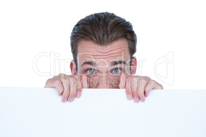 Man hiding by blank paper